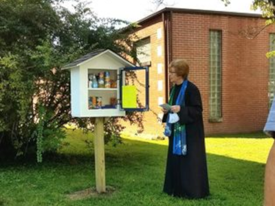 Pastor in 
front of a new blessing box